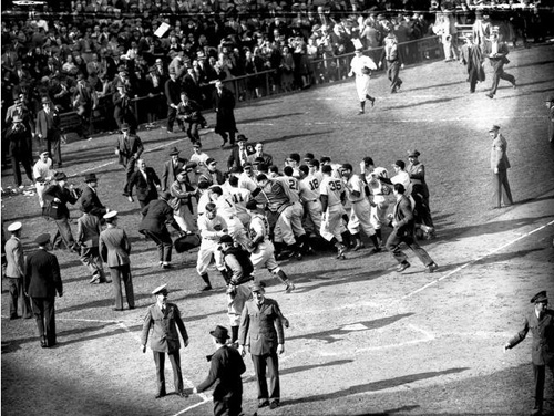 Reds mob Paul Derringer after final out of 1940 World Series.